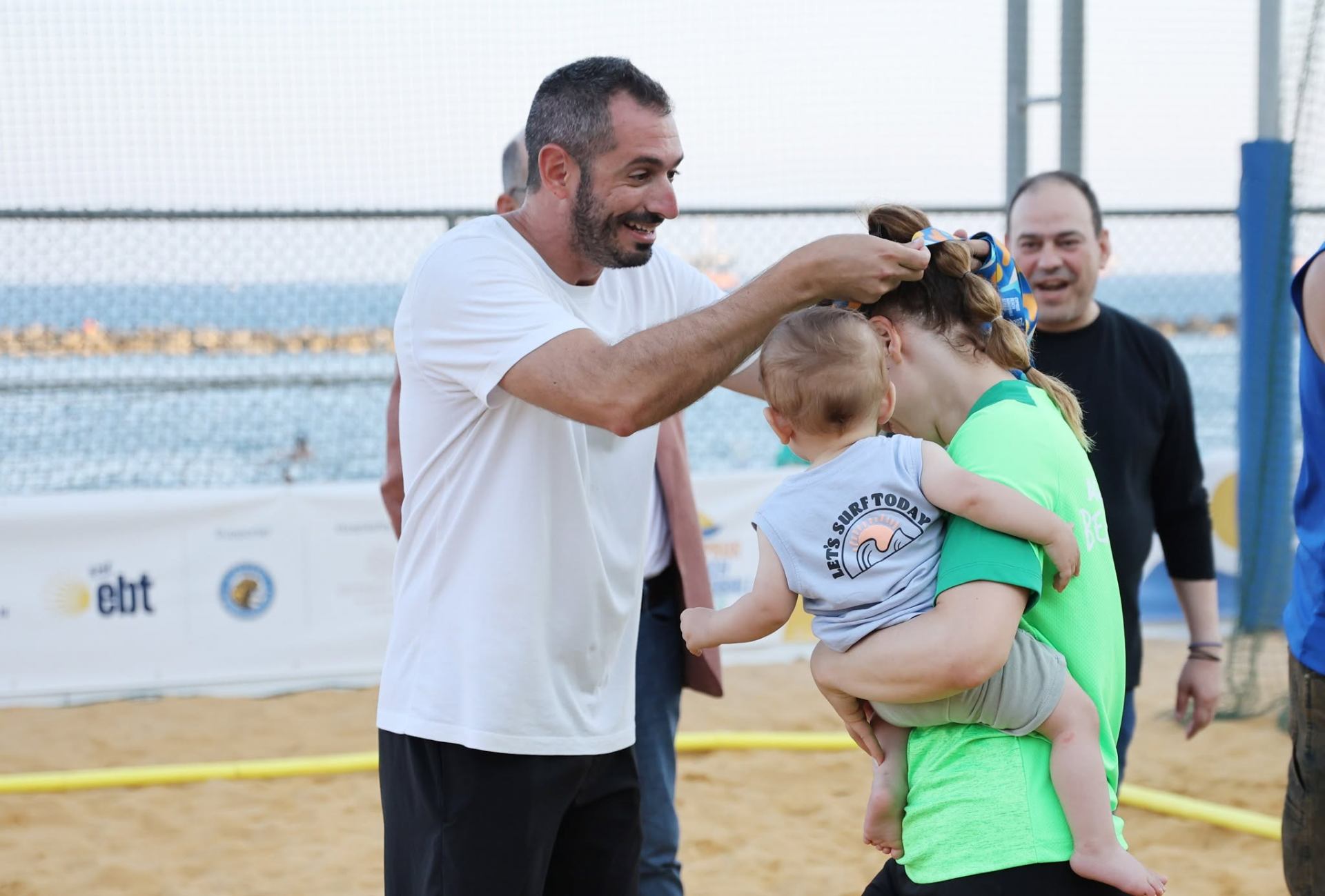 Medal ceremony with a little one in mum's arms — 2026/27