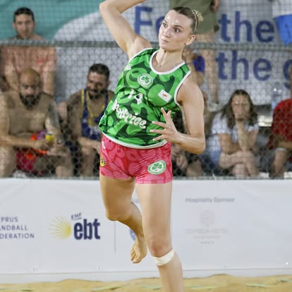 Omonoia player mid-air jump shot in green kit — 2026/27